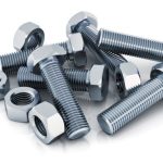 Creative abstract industrial business concept: macro view of shiny metal bolts and nuts isolated on white background with reflection effect